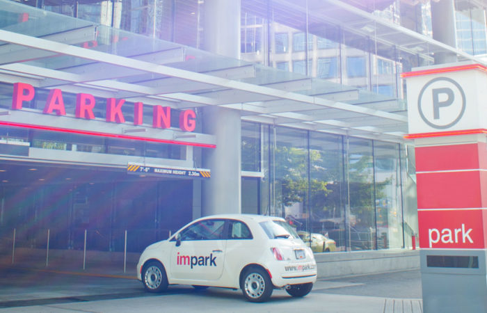 An Impark-branded Fiat 500 entering a well-kept, Impark-managed parking facility.